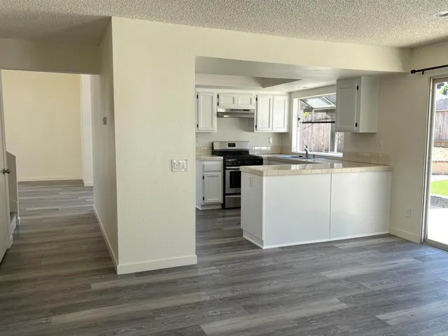 a kitchen with stainless steel appliances granite countertop a stove and a refrigerator