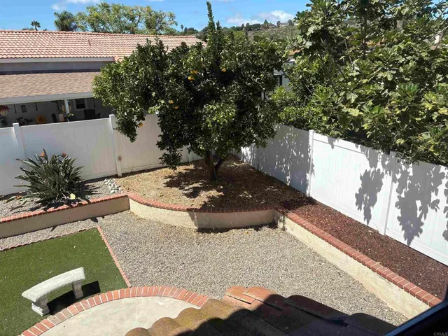 a view of a backyard with plants and a lake view