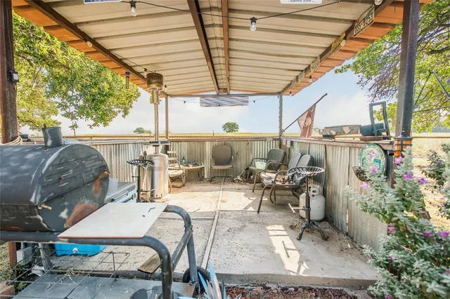 a view of a patio with table and chairs and potted plants