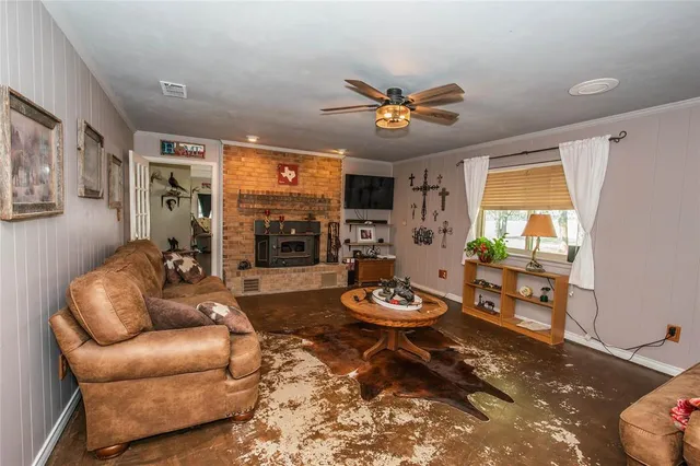 a living room with furniture a rug and a window