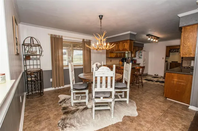 a view of a dining room with furniture window and outside view