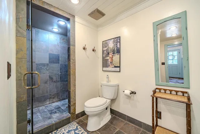 a bathroom with a toilet and a shower