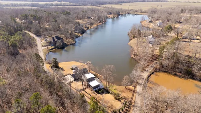 an aerial view of a house with outdoor space and lake view