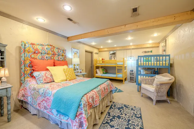 a bedroom with a bed a couch and dresser