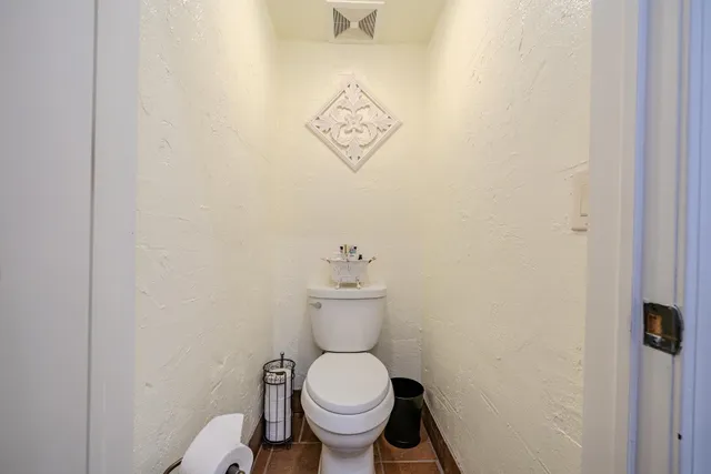 a white toilet sitting next to a bathroom sink