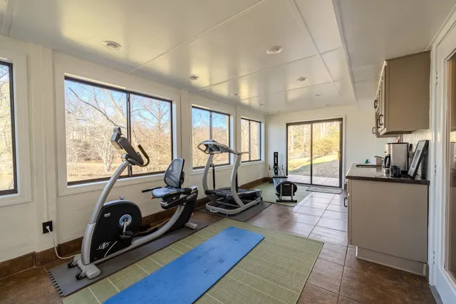 a view of a room with gym equipment and windows