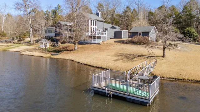 an aerial view of a house with swimming pool and patio