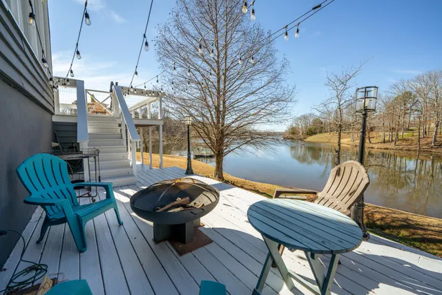 a view of a dinning table and chairs on the roof deck