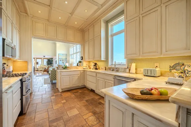 a kitchen that has a sink and a stove in it