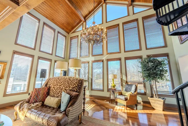a living room with furniture and floor to ceiling windows