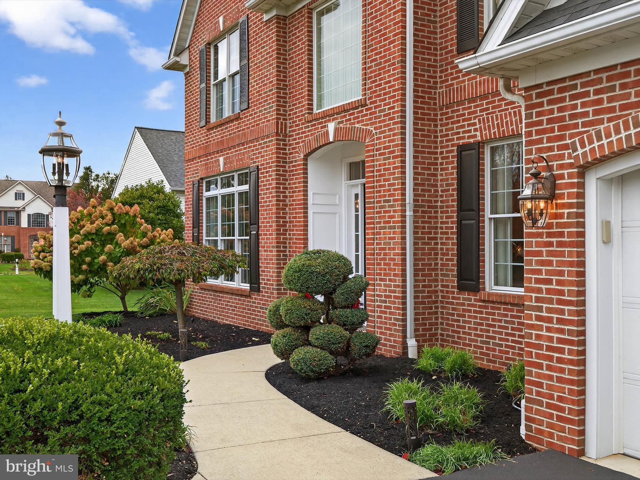 213 Barkay Crossing Lititz, PA 17543 - Photo 12 of 112 a view of a brick house with a large windows and potted plants