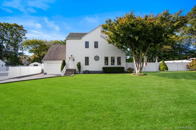 a front view of house with yard and green space