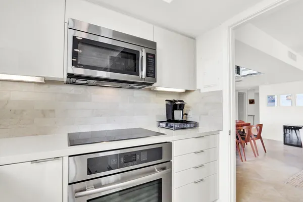 a kitchen with granite countertop cabinets and steel stainless steel appliances