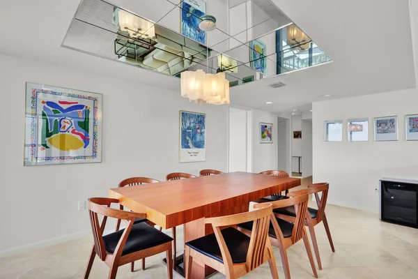 a dining room with furniture and chandelier
