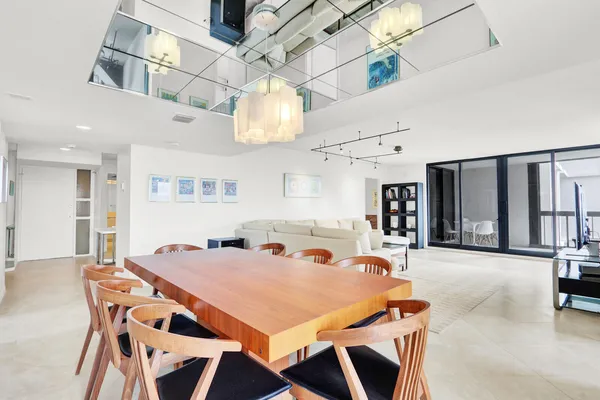 a view of a dining room with furniture and chandelier