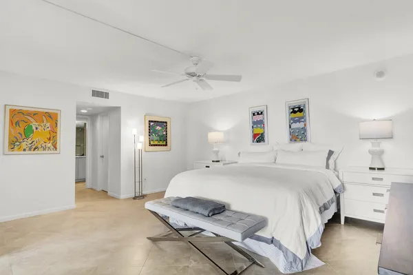 a bedroom with a bed and a lamp