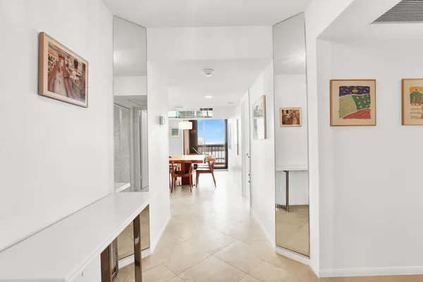 a view of dining room with kitchen island stainless steel appliances refrigerator sink and dining table