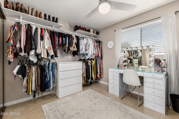 a view of walk in closet with clothes and shoes