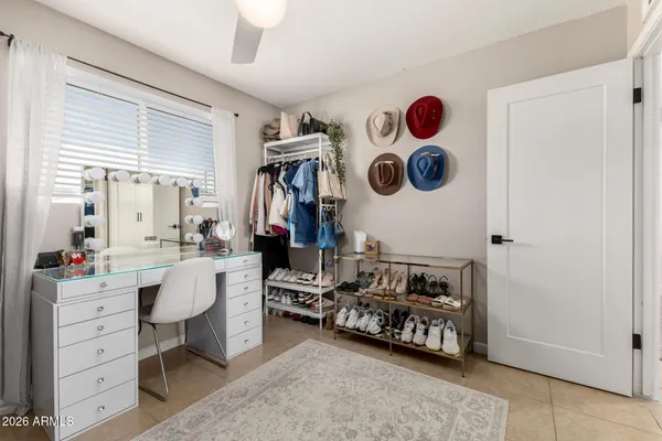 a bedroom with furniture and a mirror