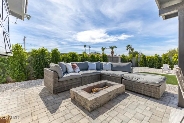 a view of a patio with couches and a fire pit