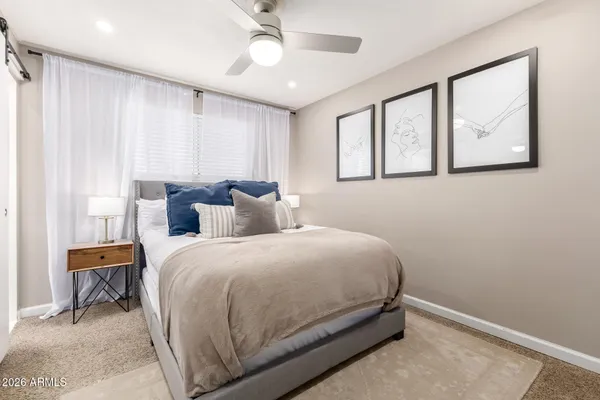 a bedroom with a bed and a window