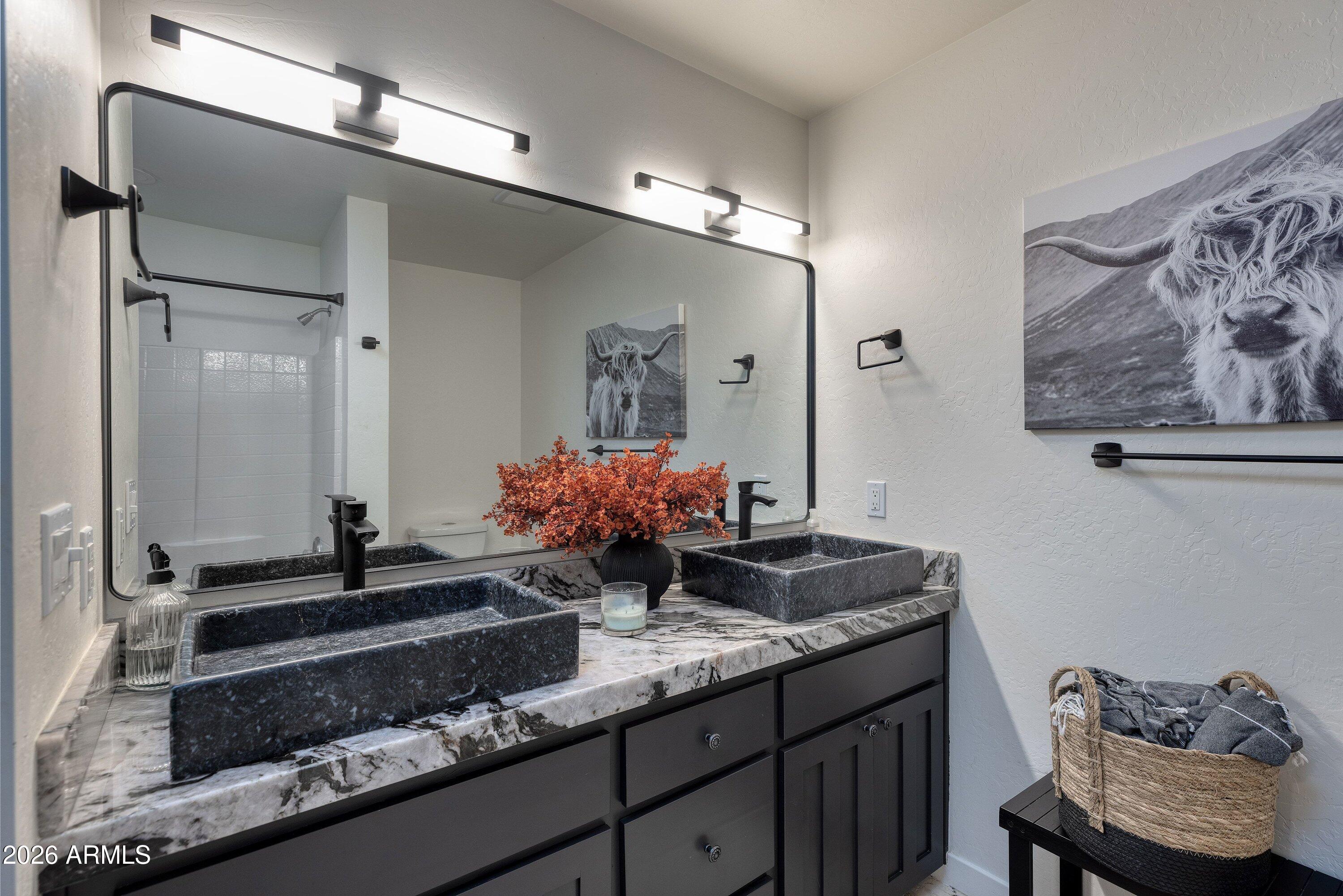 5182 Pinedale Wash Road Pinedale, AZ 85934 - Photo 25 of 54 a bathroom with a granite countertop sink a toilet and a mirror