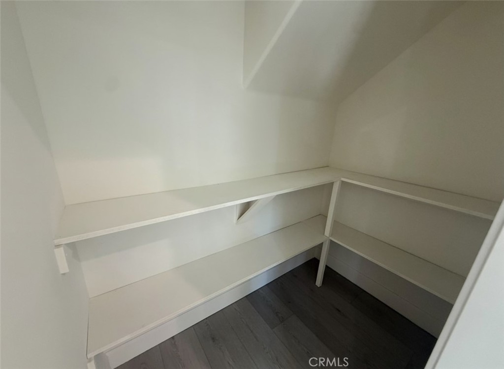 15909 Merrill Avenue, Unit 10 Fontana, CA 92335 - Photo 5 of 14 a storage room with wooden floor