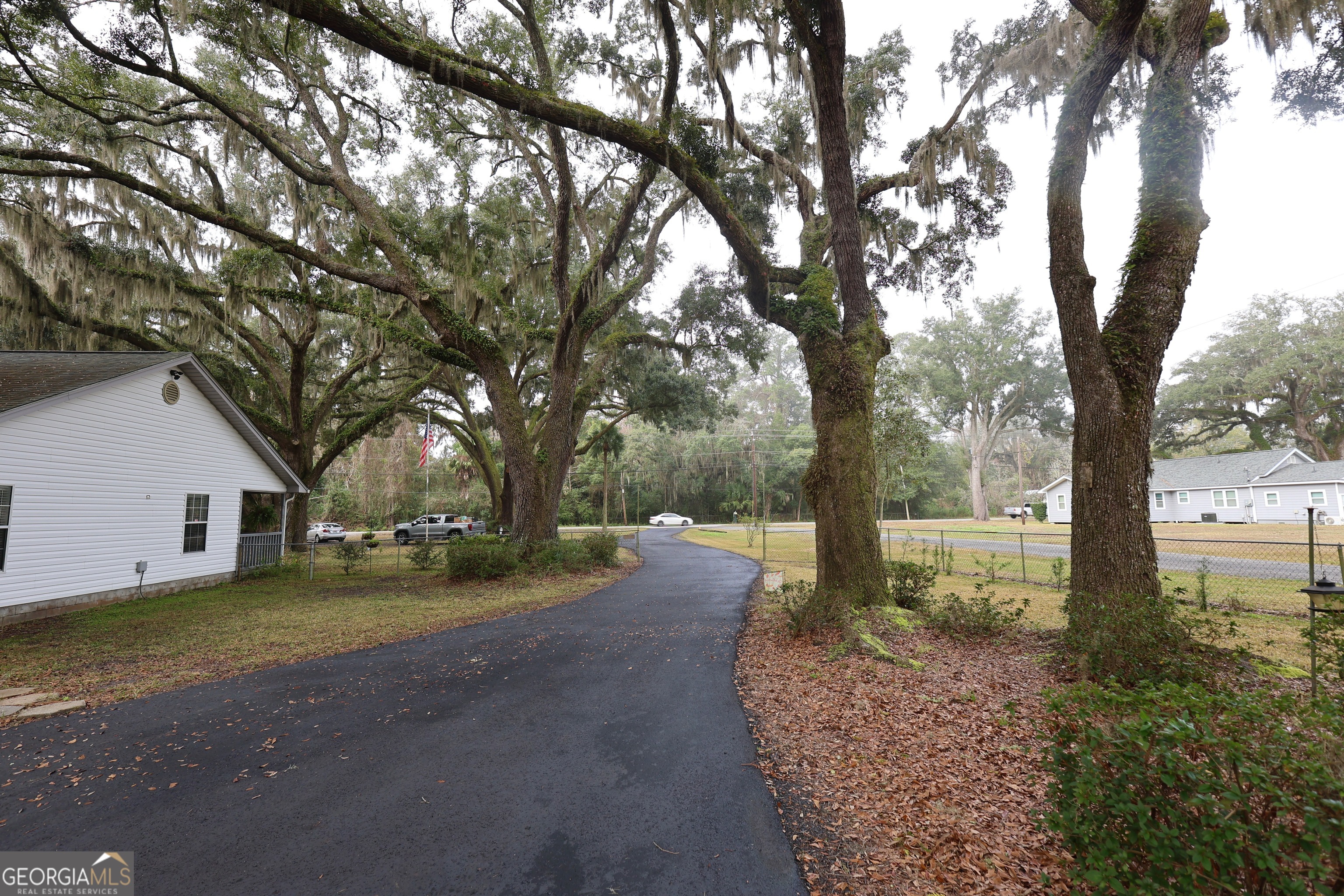 950 Old Jesup Road Brunswick, GA 31520 - Photo 3 of 20 a view of a house with trees in the background