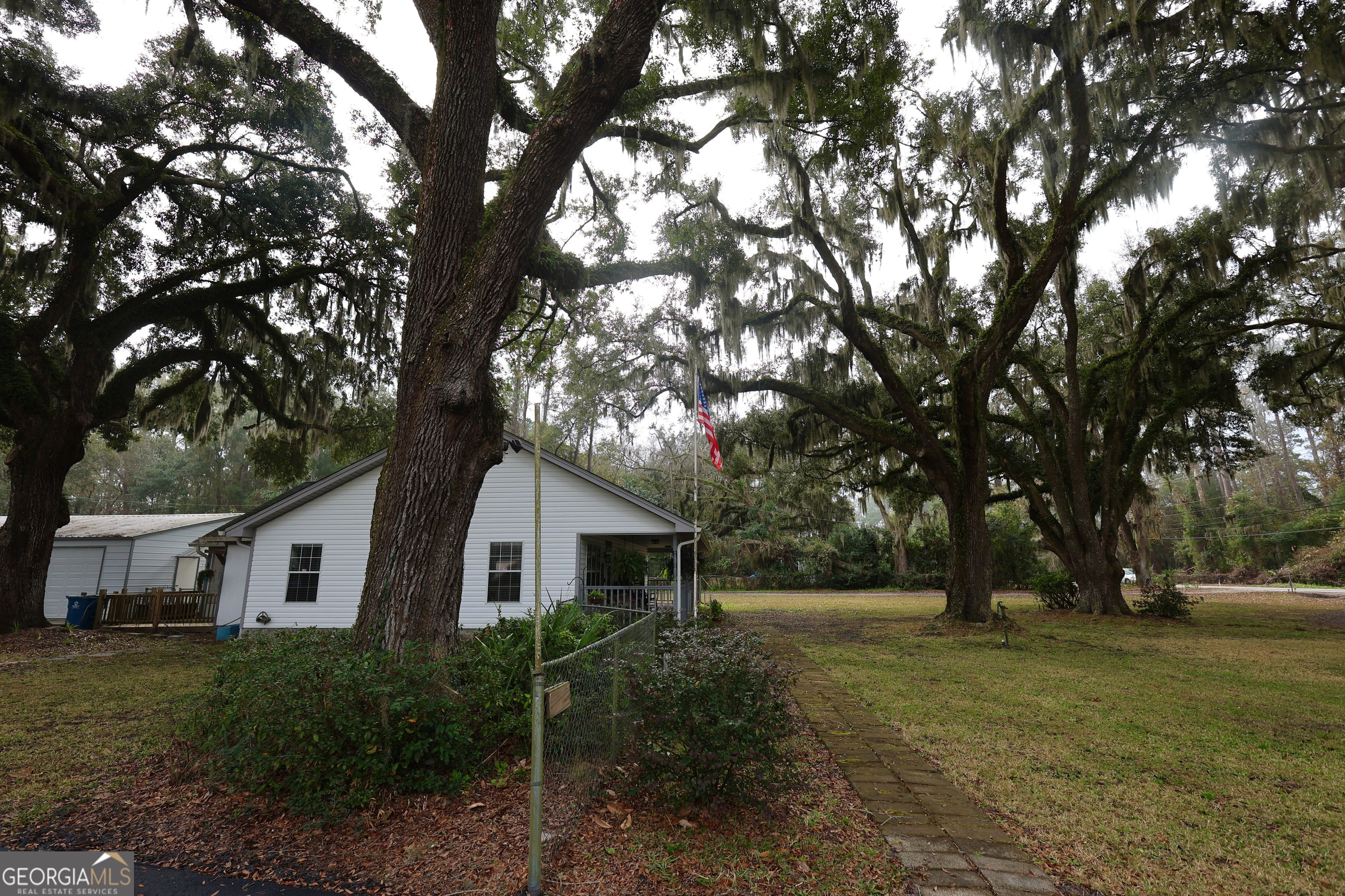 950 Old Jesup Road Brunswick, GA 31520 - Photo 4 of 20 a front view of a house with a yard and trees