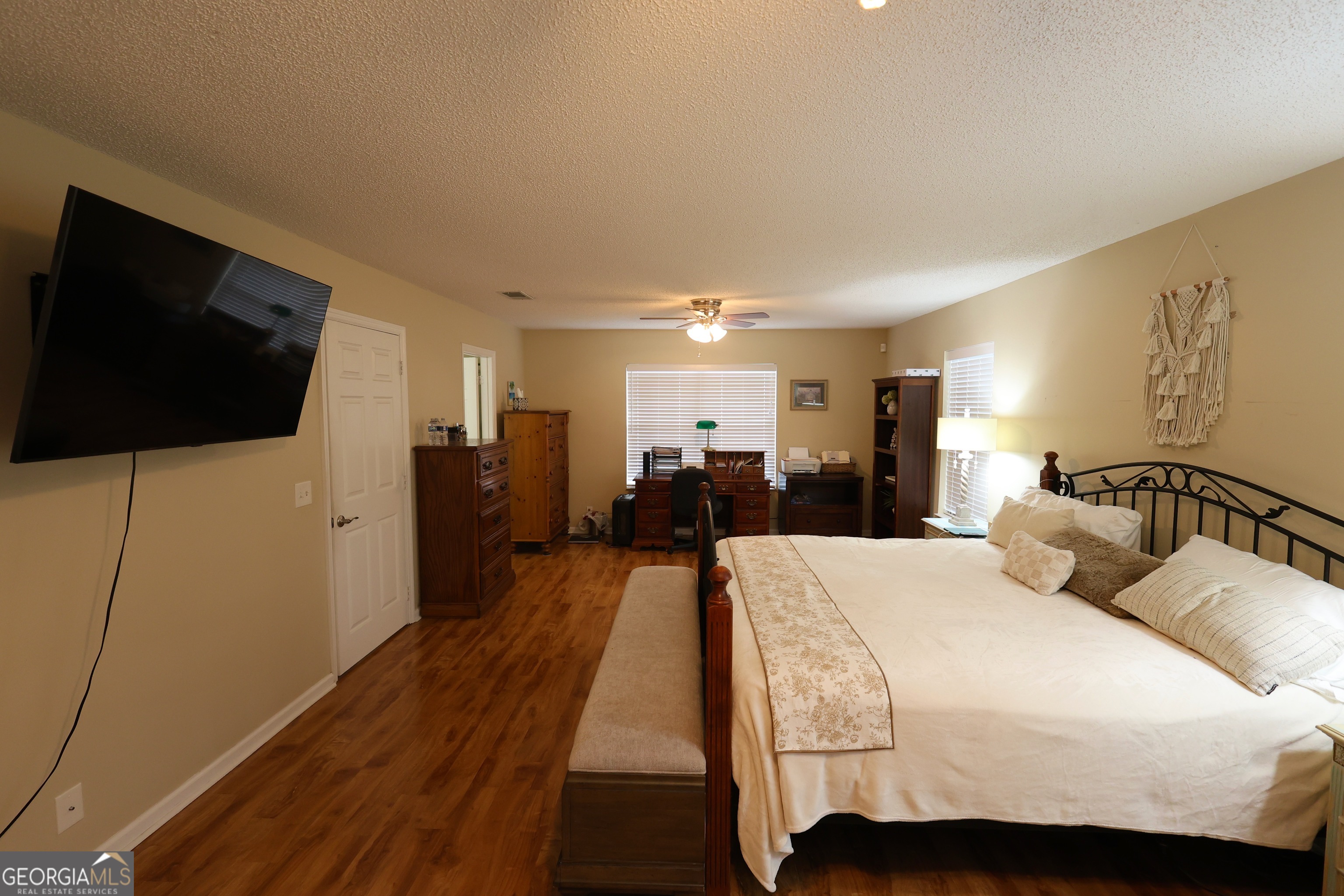 950 Old Jesup Road Brunswick, GA 31520 - Photo 10 of 20 a large bedroom with a bed and a flat screen tv