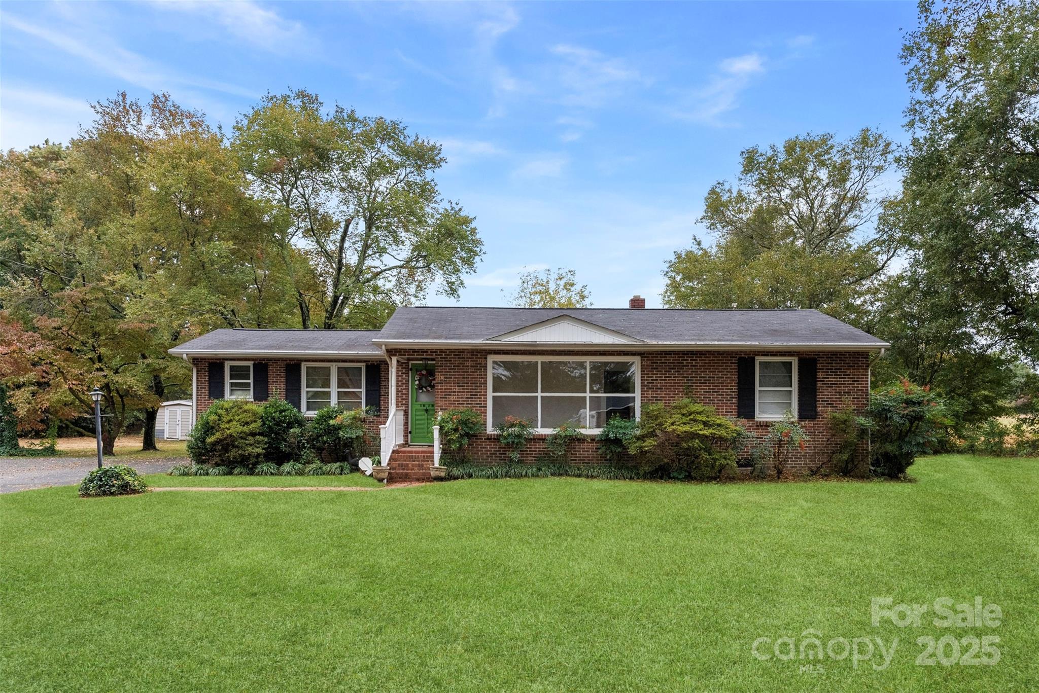 a view of a house with yard and green space