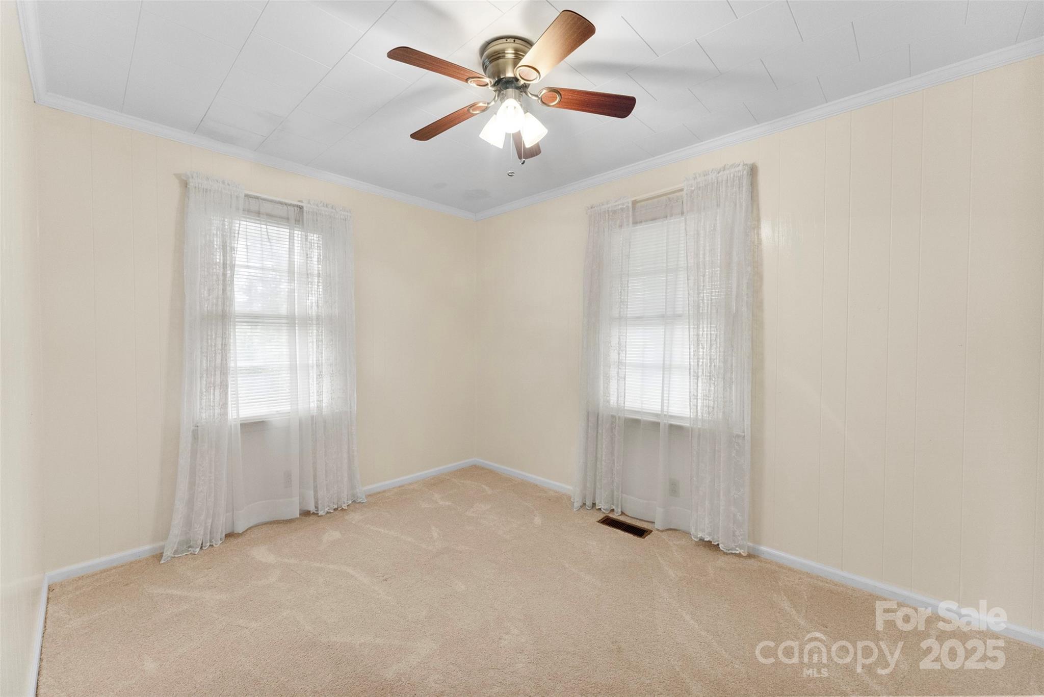 1819 Ratchford Road Dallas, NC 28034 - Photo 17 of 38 an empty room with chandelier fan and windows