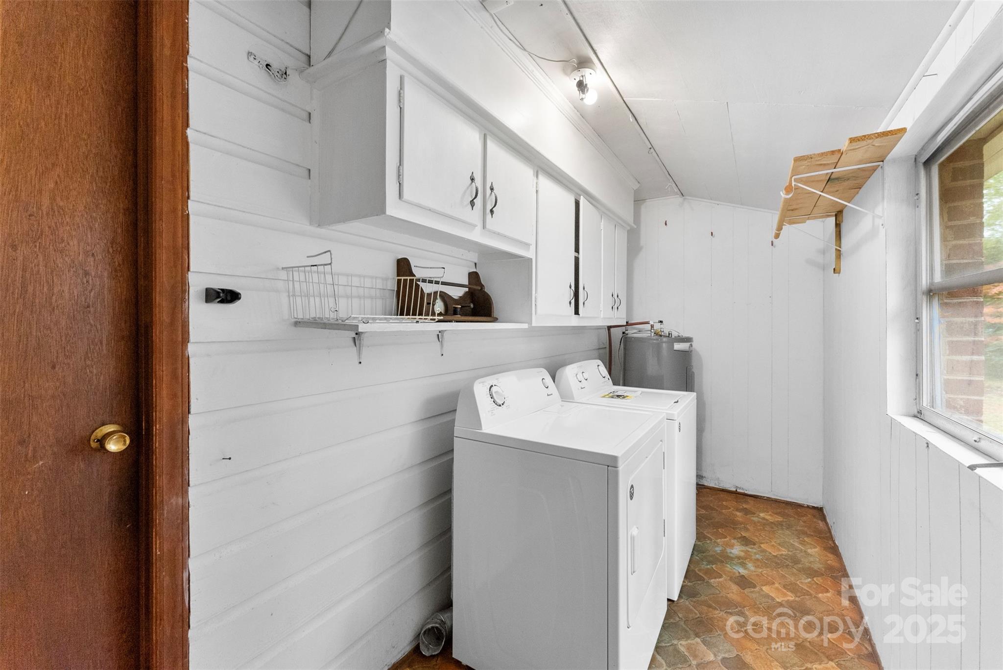 1819 Ratchford Road Dallas, NC 28034 - Photo 30 of 38 a utility room with cabinets washer and dryer