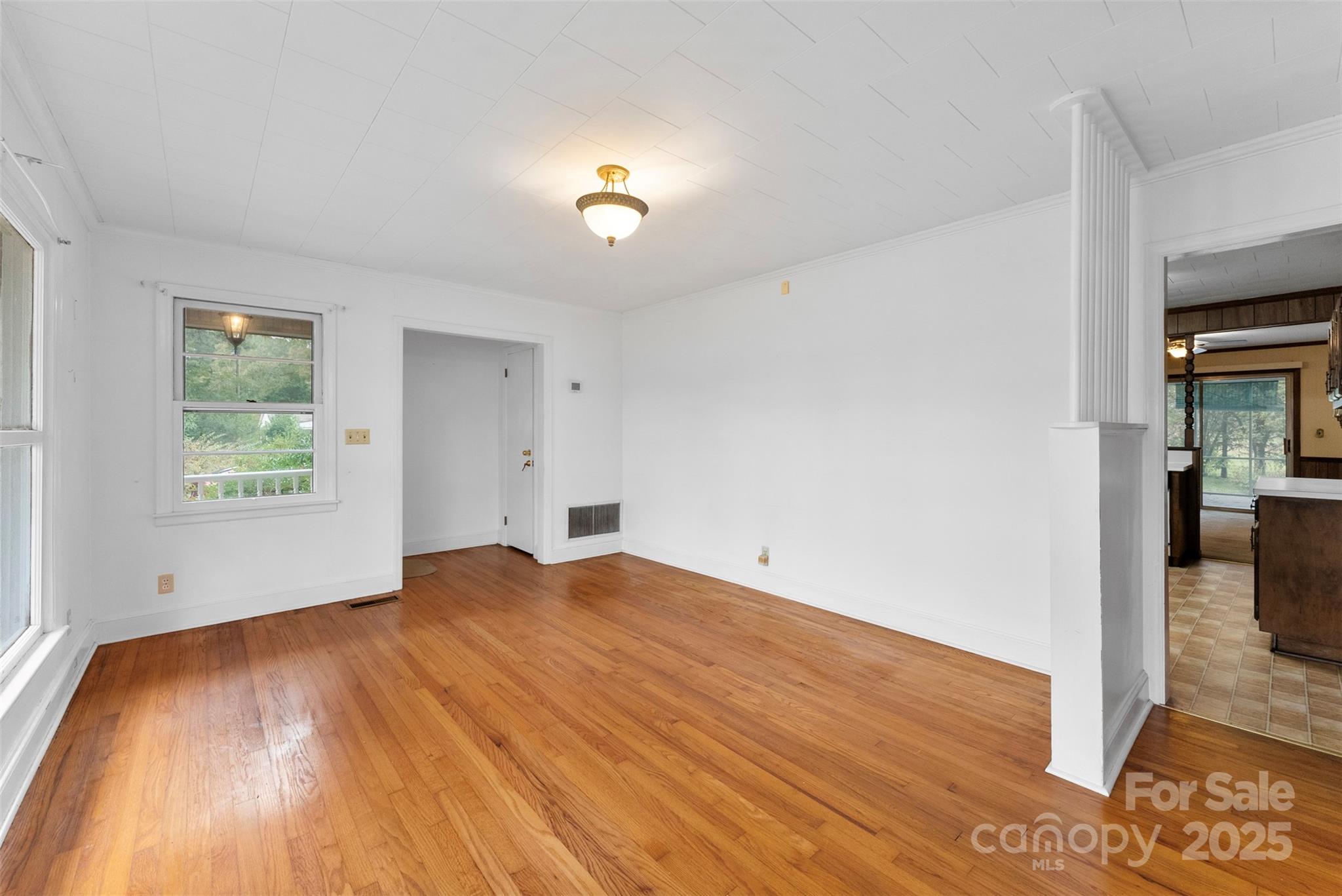 1819 Ratchford Road Dallas, NC 28034 - Photo 5 of 38 a view of empty room with wooden floor and fan