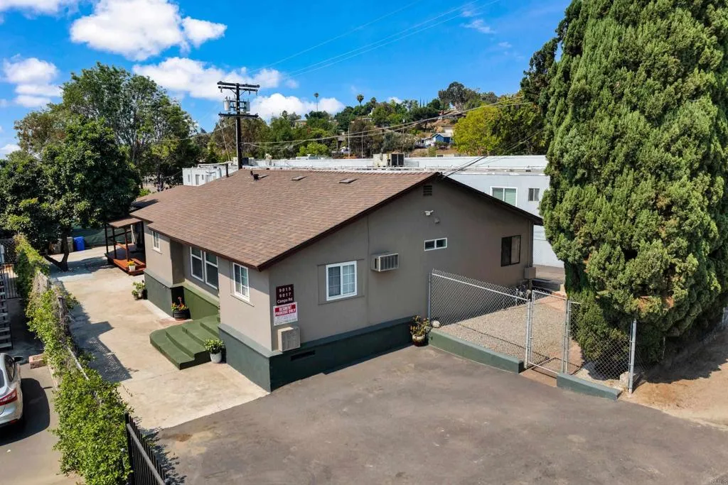 a aerial view of a house with a yard and potted plants