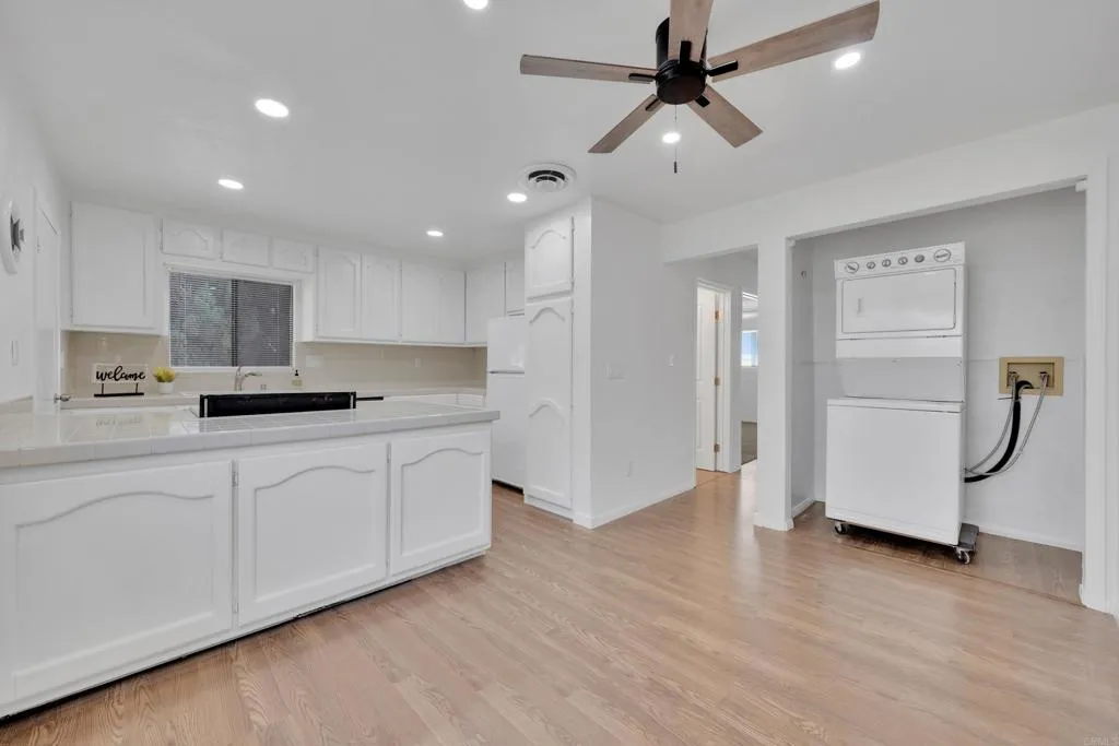 9015 Campo Road Spring Valley, CA 91977 - Photo 13 of 58 a kitchen with kitchen island granite countertop appliances cabinets and a sink