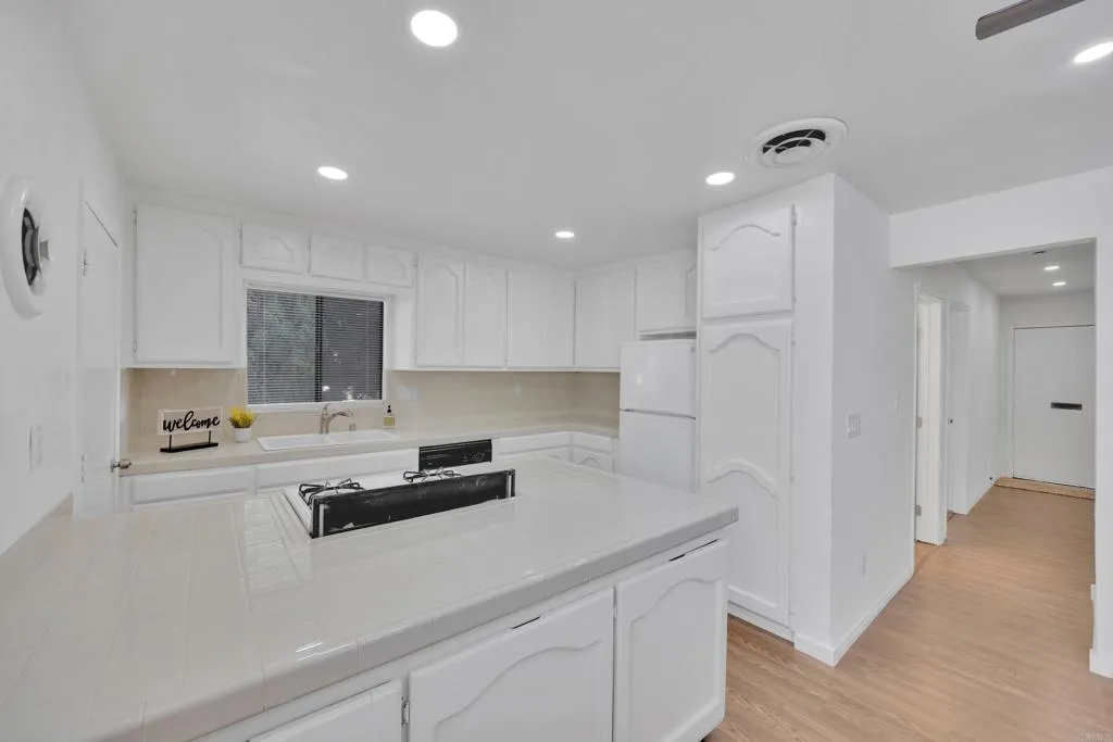 9015 Campo Road Spring Valley, CA 91977 - Photo 14 of 58 a kitchen with kitchen island a sink stainless steel appliances and cabinets