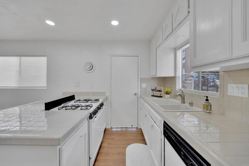 9015 Campo Road Spring Valley, CA 91977 - Photo 15 of 58 a kitchen that has a sink and a stove