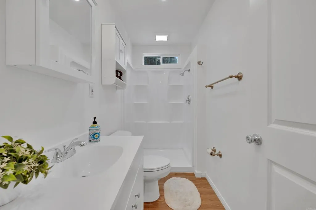 9015 Campo Road Spring Valley, CA 91977 - Photo 20 of 58 a bathroom with a sink a toilet and shower