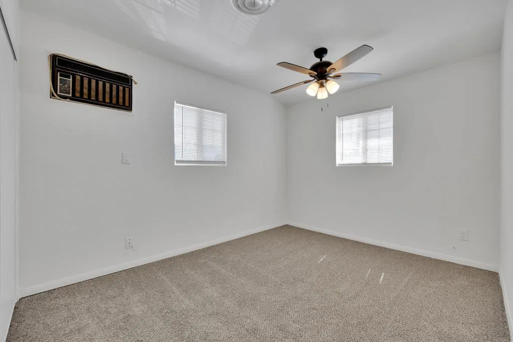 9015 Campo Road Spring Valley, CA 91977 - Photo 22 of 58 an empty room with a window and a fan