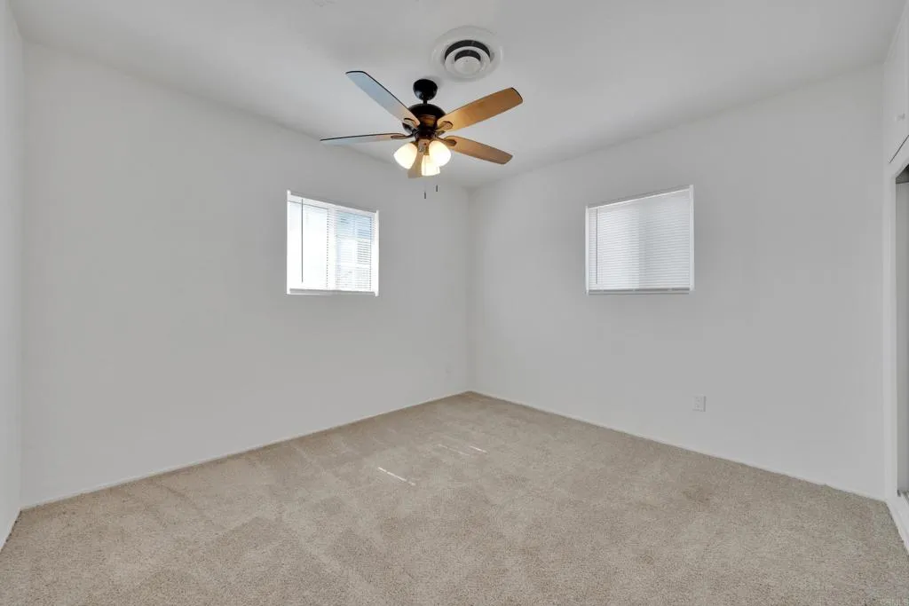 9015 Campo Road Spring Valley, CA 91977 - Photo 25 of 58 an empty room with windows and fan