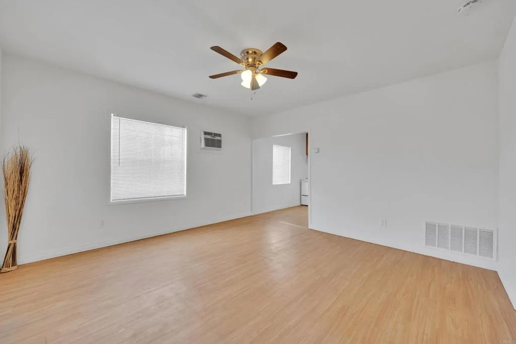9015 Campo Road Spring Valley, CA 91977 - Photo 32 of 58 wooden floor in an empty room with a window