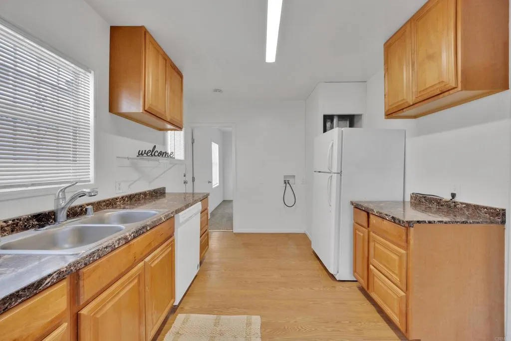 9015 Campo Road Spring Valley, CA 91977 - Photo 35 of 58 a kitchen with stainless steel appliances granite countertop a sink a stove and a refrigerator