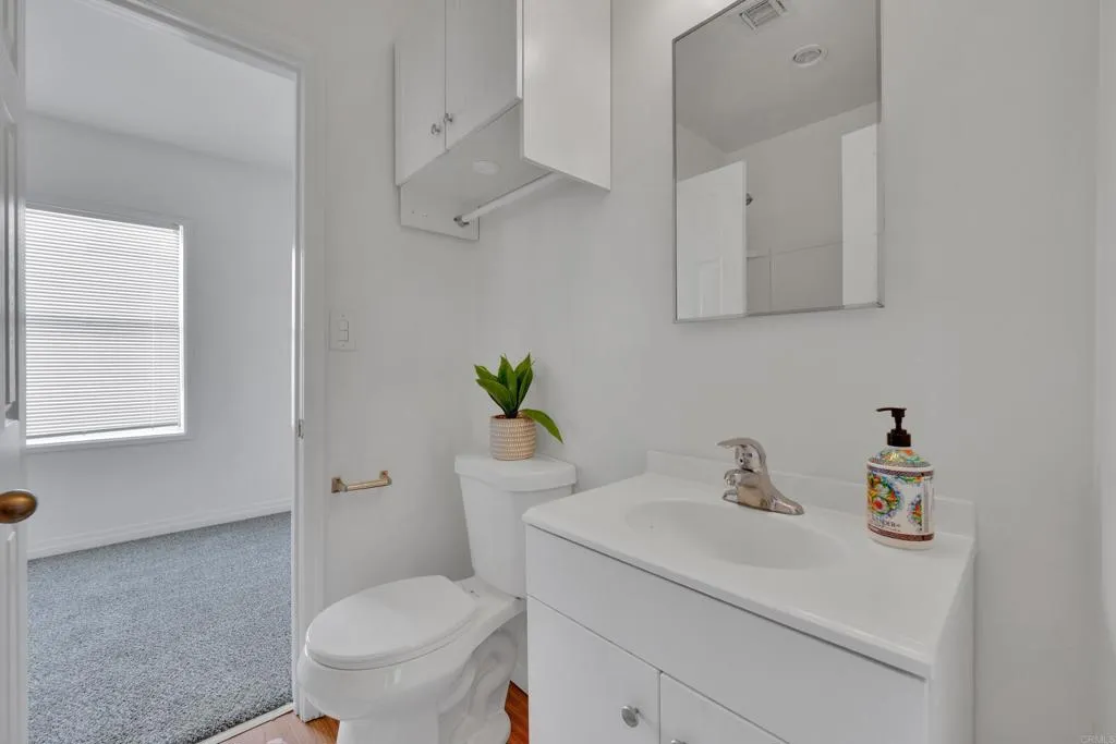 9015 Campo Road Spring Valley, CA 91977 - Photo 40 of 58 a bathroom with a sink toilet and mirror
