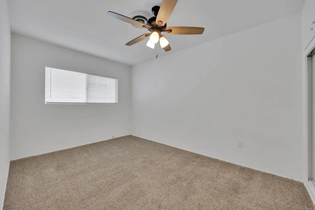 9015 Campo Road Spring Valley, CA 91977 - Photo 42 of 58 a view of an empty room with a ceiling fan and a window