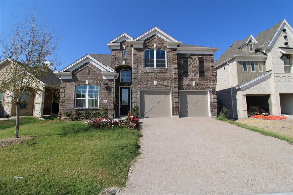 8407 Cornerstone Drive Rowlett, TX 75088 - Photo 25 of 25 Two-story brick facade residence featuring a two-car garage, arched entry, and a manicured front lawn with mature landscaping