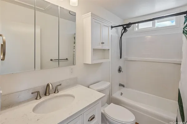 a bathroom with a sink toilet tub and shower