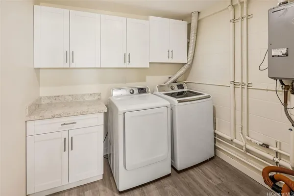 a view of a storage and utility room with washer and dryer