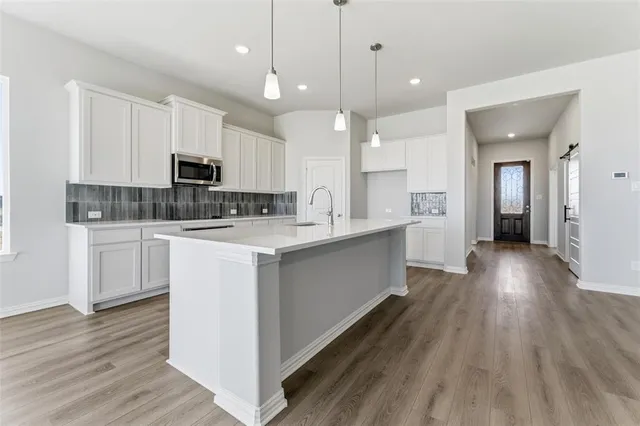 an empty room with fan and windows
