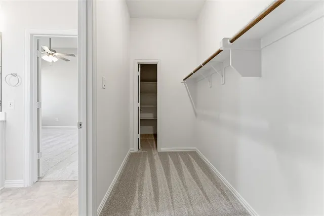 a view of a hallway with wooden floor and entryway